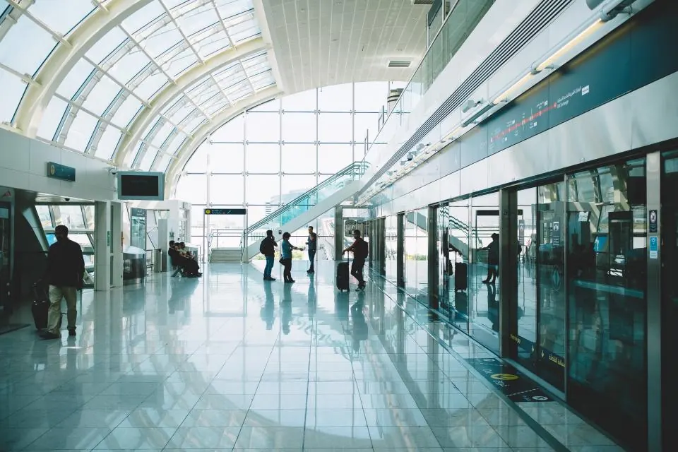 Passengers walking through a bright airport terminal